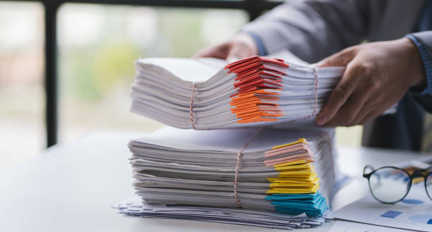 istock business documents businessman check legal document review Prepare documents or analysis reports, tax items, accounting documents, data contracts, office partner agreements. 1410322730