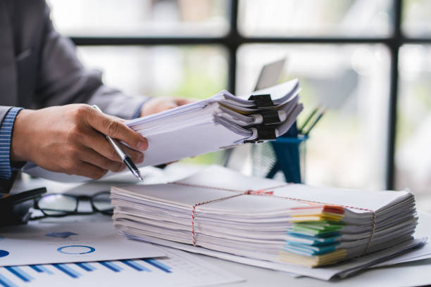 istock business documents businessman check legal document review Prepare documents or analysis reports, tax items, accounting documents, data contracts, office partner agreements. 1410323210