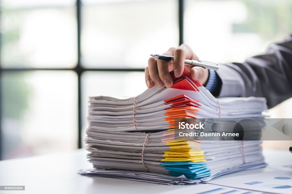 business documents businessman check legal document review Prepare documents or analysis reports, tax items, accounting documents, data contracts, office partner agreements. Document Stock Photo