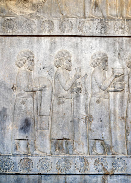 istock Ancient wall with bas-relief with assyrian foreign ambassadors with gifts and donations, Persepolis, Iran 1410323390