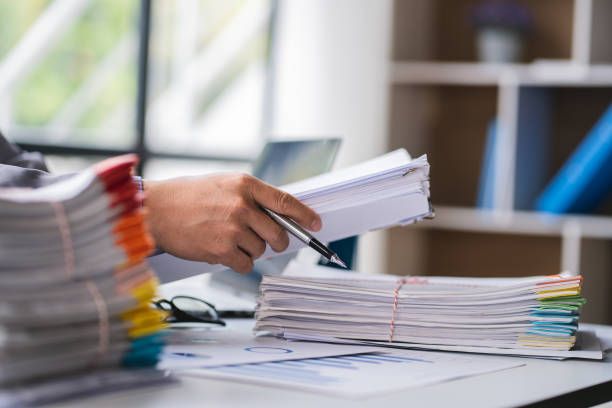 istock business documents businessman check legal document review Prepare documents or analysis reports, tax items, accounting documents, data contracts, office partner agreements. 1410323454