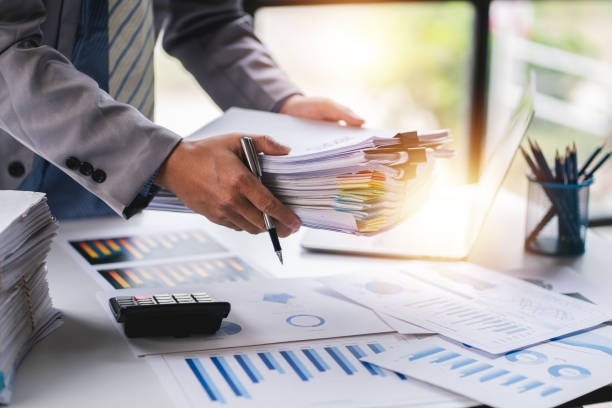 istock business documents businessman check legal document review Prepare documents or analysis reports, tax items, accounting documents, data contracts, office partner agreements. 1410323838