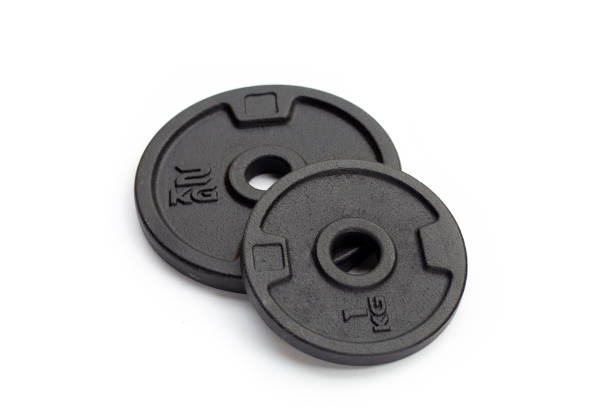 istock Black weight plates on white background. Gym equipment 1410325610