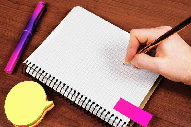 Man writing with a ballpoint pen. Handwriting