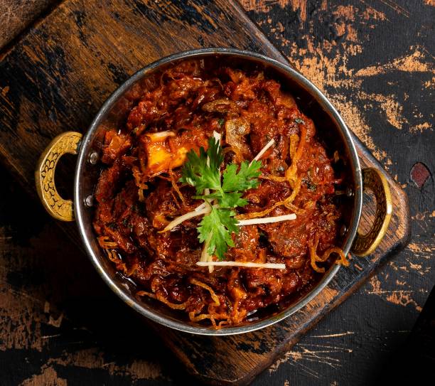 Mutton Sukka karahi served in a dish isolated on dark background top view stock photo