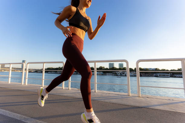 istock Female athlete training next to a river 1410336665