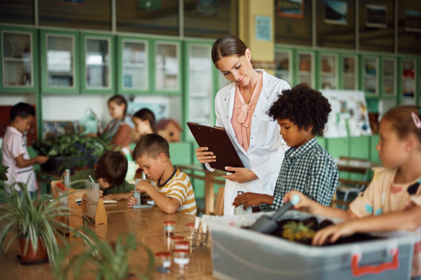 istock Botany teacher and school kids during class in the classroom. 1410337589
