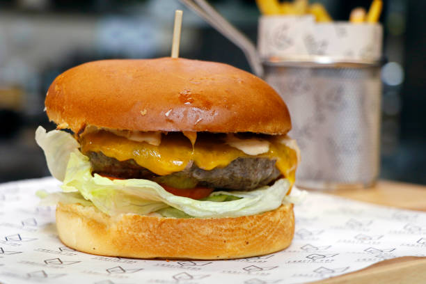 istock angus beef burger with cheddar cheese, tomatoes,eggs and lettuce in close up 1410339401