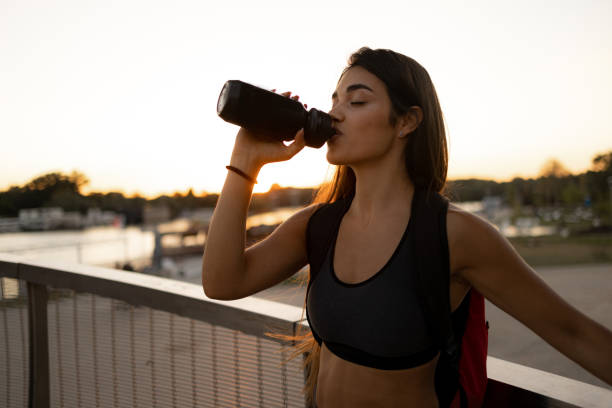 istock Attractive female athlete taking a short break from training 1410339601