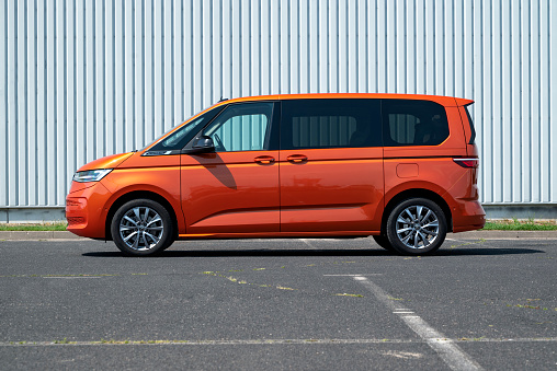 Berlin, Germany - 22 July, 2022: Volkswagen Multivan T7 eHybrid on a public parking. This car is one of the most popular minibus vehicles in Europe.