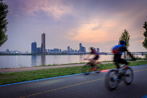 Seoul skyline and bikers cycling