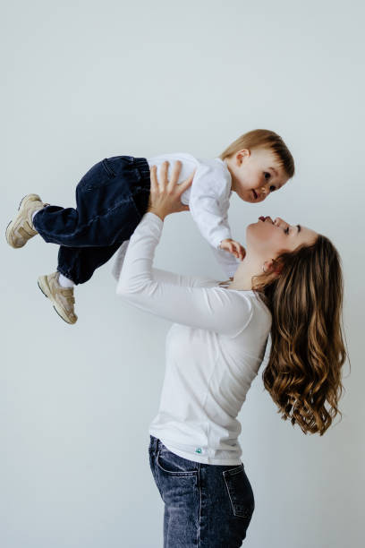 istock Happy young mother with her son over white background 1410347139
