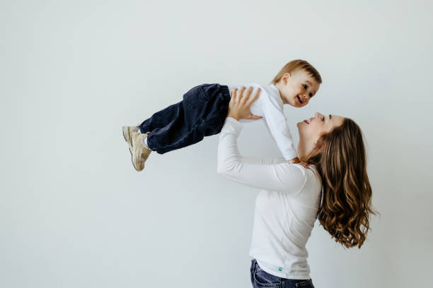 istock Happy young mother with her son over white background 1410347720