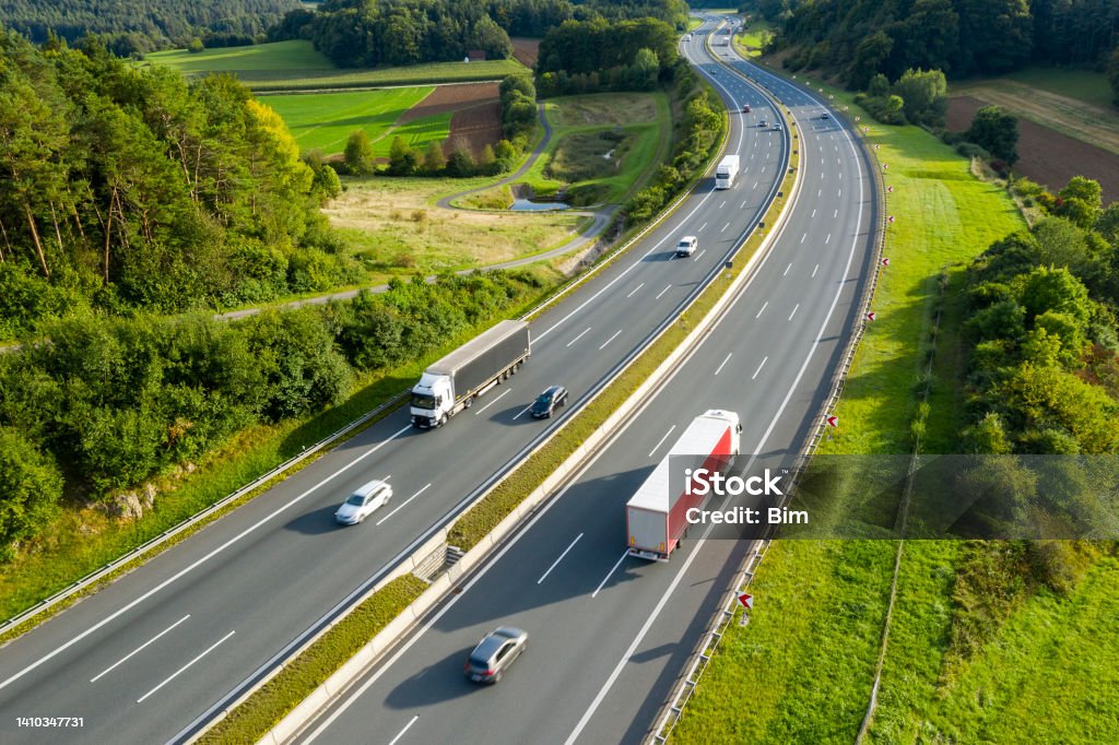 Multiple Lane Highway with Trucks and Cars from Above Aerial view of multiple lane rural highway with trucks. Road Stock Photo