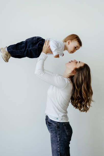 istock Happy mother and baby having fun on a white background 1410347774