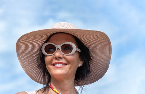 Woman wearing sunglasses and straw hat