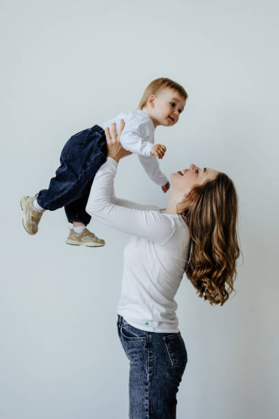 istock Happy mother and baby having fun on a white background 1410348059