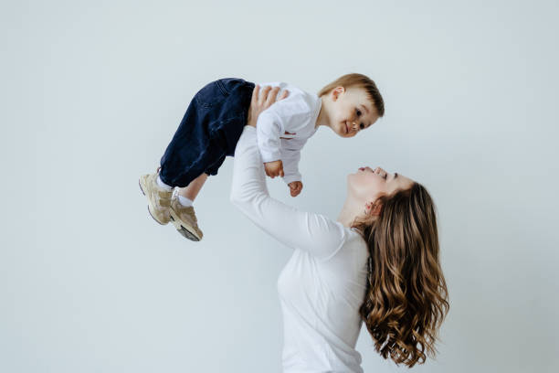 istock Happy mother and baby having fun on a white background 1410348319