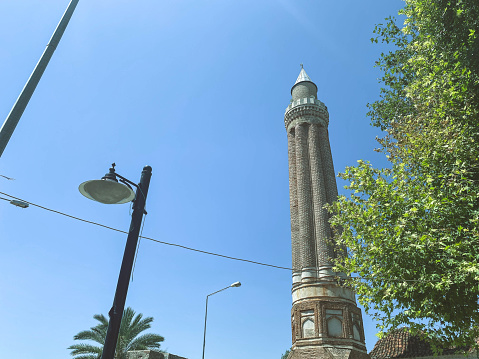 area in a hot, tropical country. high tower with windows against the blue sky. exotic nature. tower with a high stone spire.