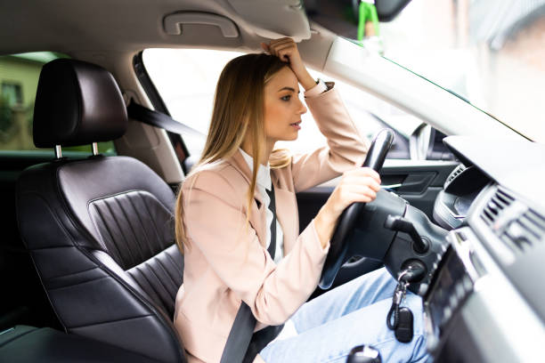 istock Stressed woman driver sitting inside her car on the road 1410350722