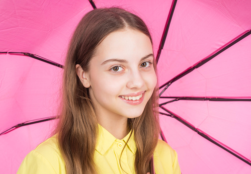 rainy weather forecast. back to school. childhood. fall fashion accessory. happy stylish girl isolated on white. cheerful teen child hold pink parasol. kid in hat with pink umbrella. autumn season.