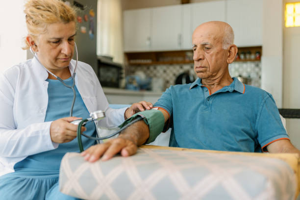 istock Health visitor checking patient's blood pressure during home visit 1410352669