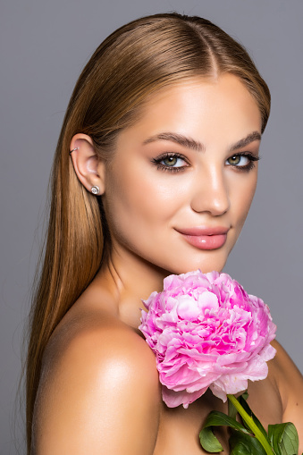 young beautiful woman with pink flower