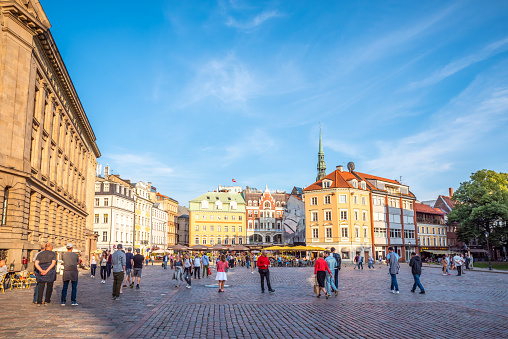 Riga, Latvia - August 7, 2019: tourists on Doma Laukums (Doms) square in Old Riga Town in summer. Riga city historical centre is a UNESCO World Heritage Site