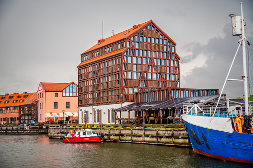 Klaipeda, Lithuania - August 09, 2019: old mill hotel in the harbor of Klaipeda in a cloudy day, Lithuania