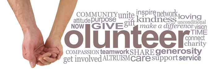 female hand cradling male hand making the V of VOLUNTEER beside a relevant word cloud against a white background