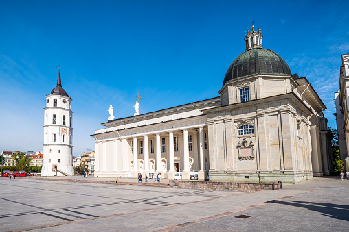 Vilnius, Lithuania - August 10, 2019: The main church and the most important square in Lithuania - in the state capital Vilnius: the Cathedral Basilica of St Stanislaus and St Ladislaus with the belfry in the Cathedral Square in the morning