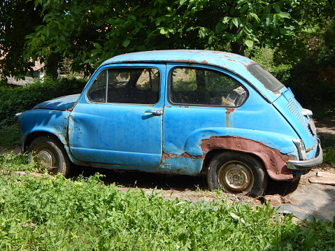 Old blue abandoned rusted car