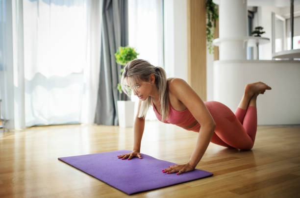 istock Young woman exercising at home. 1410358497