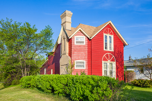 Red colored house in Brandon, Manitoba, Canada on a sunny day.