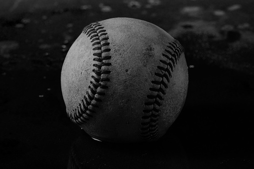 A close-up image of the seams and leather on a baseball