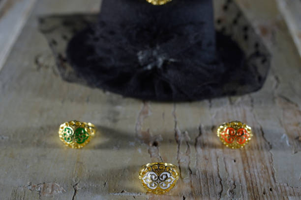 A gold ring with three little birds and the evil eye symbol on it