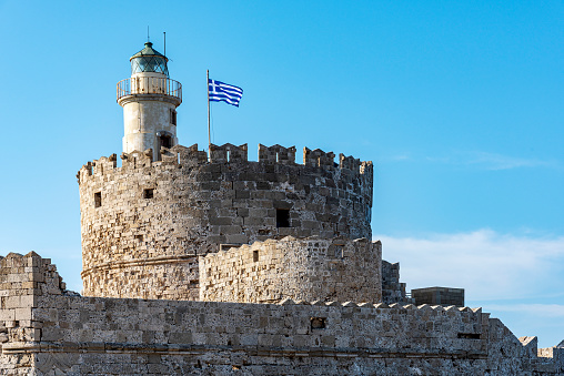 Old Saint Nicholas fortress and lighthouse in Mandraki Harbour. Rhodes, Dodecanese, Greece