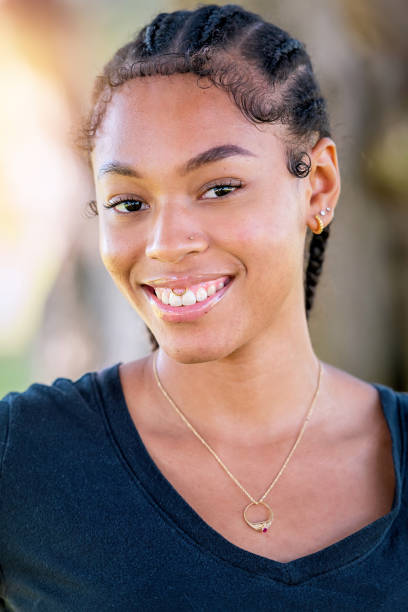 Smiling afro-latinx young woman looking at the camera Smiling afro-latinx young woman looking at the camera afro latinx ethnicity stock pictures, royalty-free photos & images