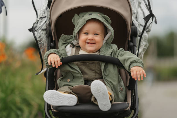 istock A female toddler is sitting in the stroller on a cloudy day. 1410373849