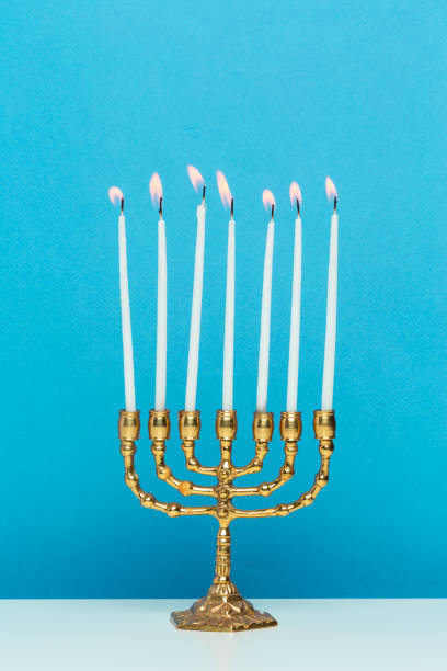 istock Bronze Hanukkah menorah with burning candles 1410374002