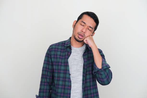 istock Adult Asian man sleeping while standing because of tiredness 1410376697