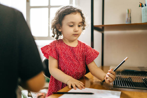 istock Little girl drawing at the desk 1410378075