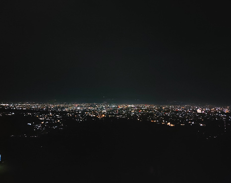 Landscape of city lights at night as seen from a plateau