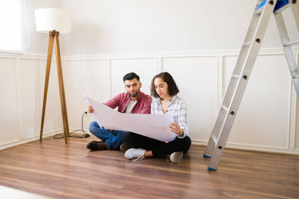 istock Young couple planning a new space while renovating their home 1410381902
