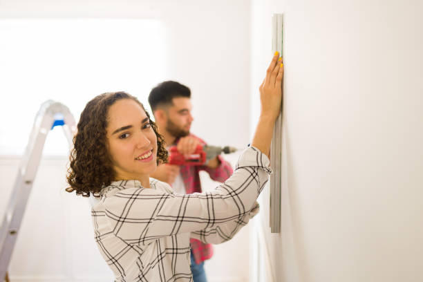 istock Smiling woman feeling cheerful while helping during home renovations 1410381948
