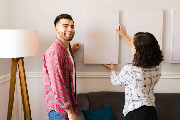 istock Happy man helping his girlfriend with home improvements 1410381996