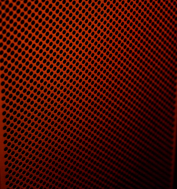 Red metal perforated background. abstract industrial surface