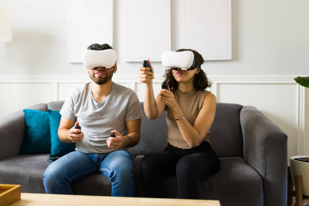 istock Young couple wearing virtual reality glasses and playing a video game 1410386051
