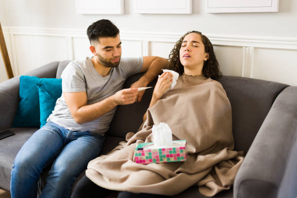 istock Caring man checking on his sick partner suffering from the flu 1410386218