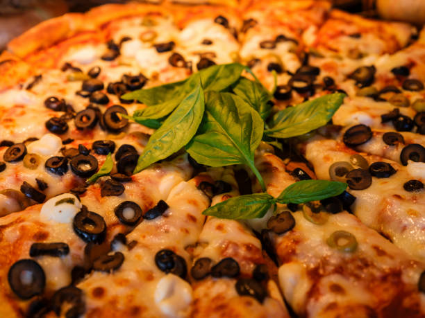Pizza with green vegetables and herbs.